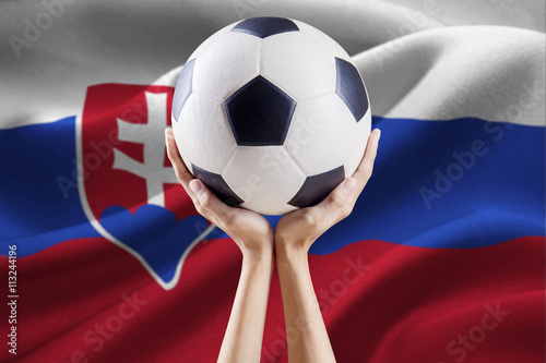 Arms holding ball with flag of Slovakia