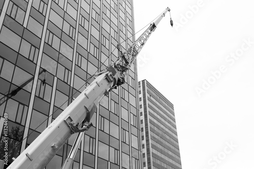 High-rise buildings with a crane in the foreground.. Black and white.