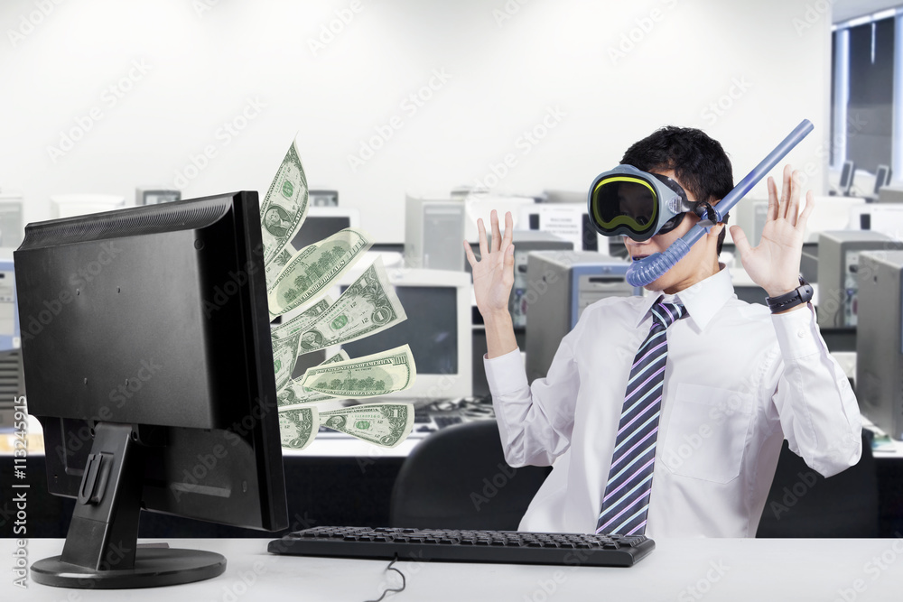 Happy businessman earns money from computer Happy businessman earns money from computer