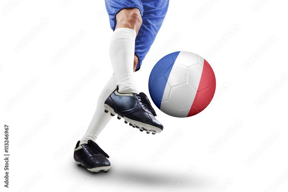 Soccer player kicks ball with a France flag