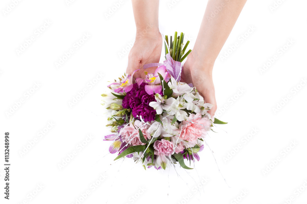 Hands holding a summer bouquet from pink and purple gillyflowers