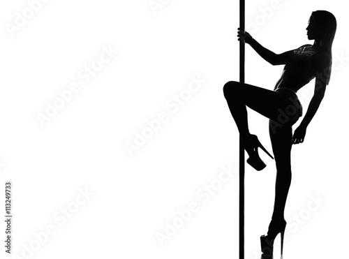 Beautiful woman performing pole dance. Studio shot, on white background. silhouette photo