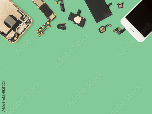 Flat Lay (Top view) of smart phone components isolate on green background with copy space