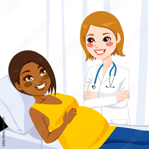 Beautiful young african american pregnant woman lying on hospital bed being visited by a female doctor