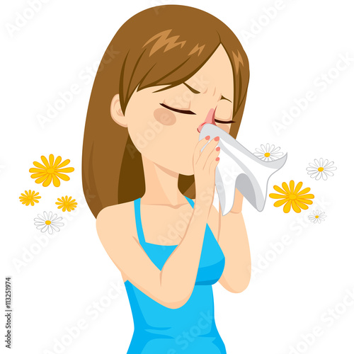 Beautiful brown haired girl sneezing blowing nose on white tissue because of spring allergy