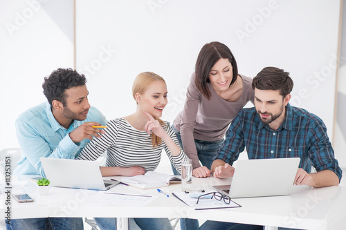 Group of young colleagues having meeting at office photo