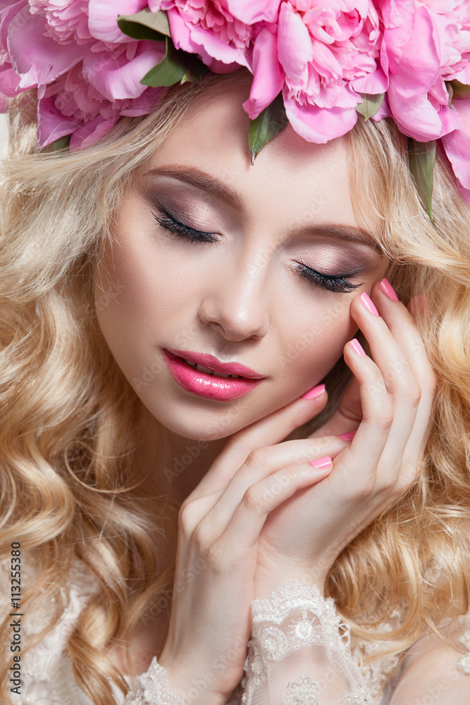 Beauty woman on a white background . Bright wavy hair and a wreath of pink peonies