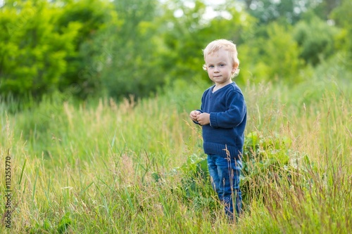 Small caucasian boy playing outdoor on meadow © milosz_g