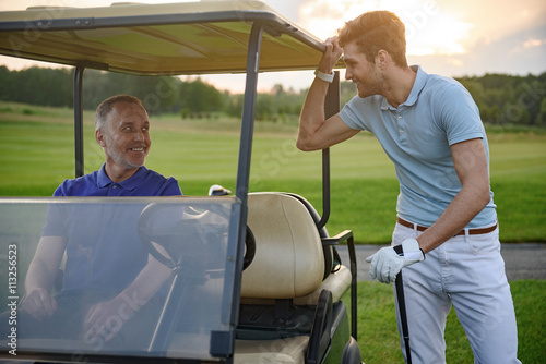 Golfer near golf cart