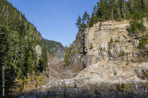 Rocky Cliff in the Valley around the mountains of British Columbia. Taken near Hope, BC, Canada, on a sunny day.