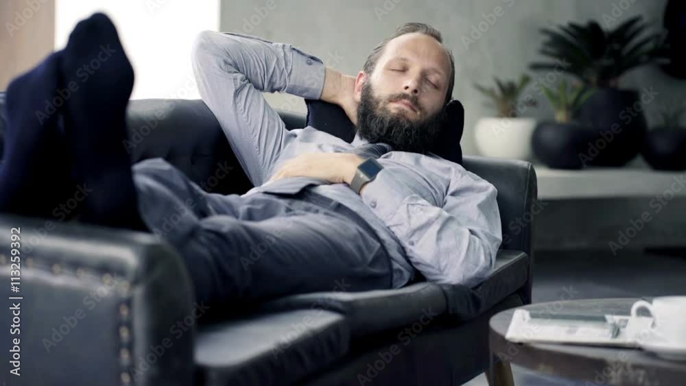 Young businessman resting, sleeping on sofa at home
Young businessman resting, sleeping on sofa at home