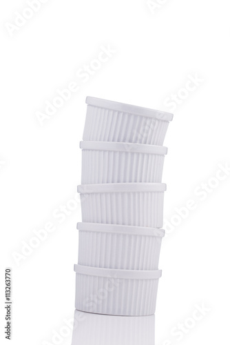 White ramekin dishes unstable stack isolated on white background
