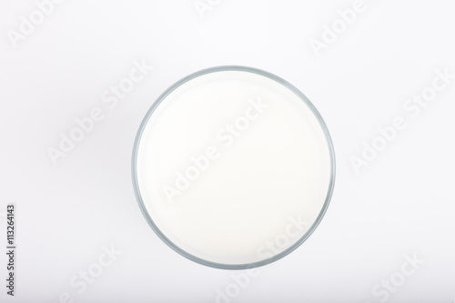 glass of milk on white background top view