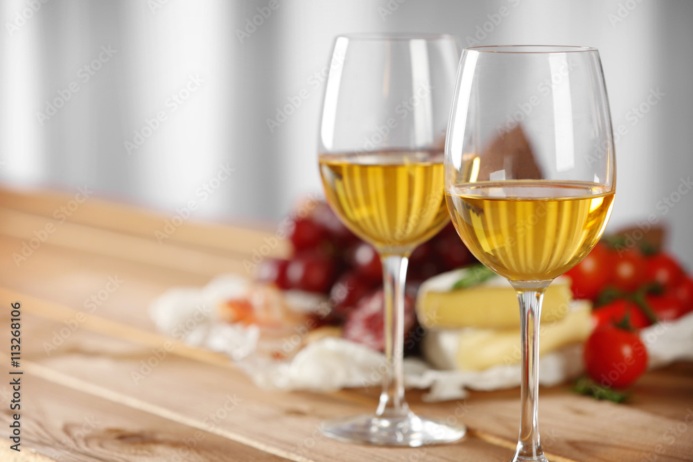 Glasses of wine with food on table closeup Glasses of wine with food on table closeup