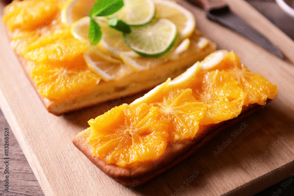 Delicious citrus cake on cutting board, closeup Delicious citrus cake on cutting board, closeup