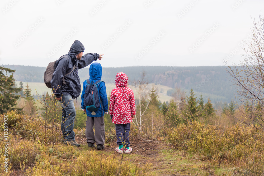 Father trekking with children