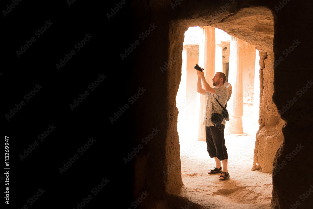Traveler taking picture of ancient ruins