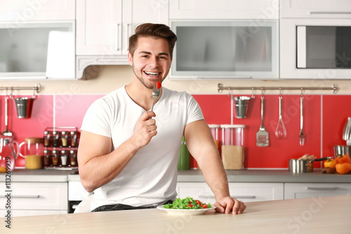 Man eating salad in the kit...