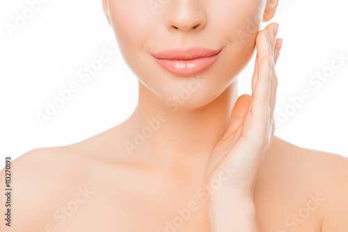 Close up of woman with perfect skin applying cream on face