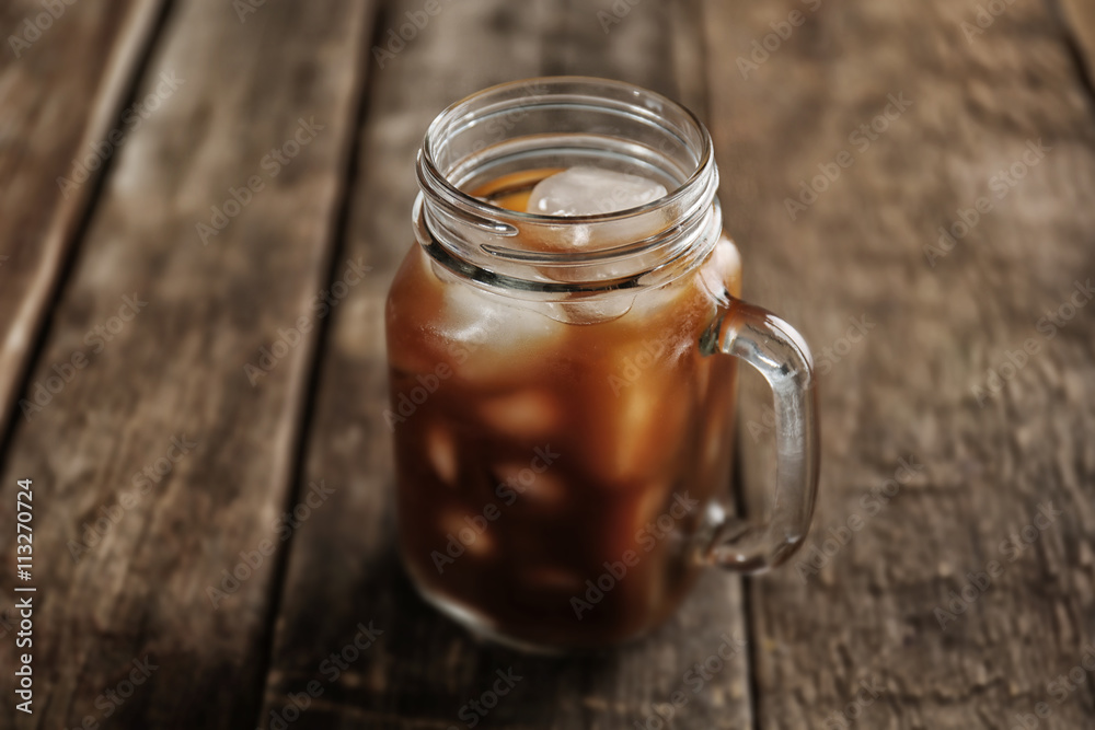 Jar of ice coffee on wooden table Jar of ice coffee on wooden table