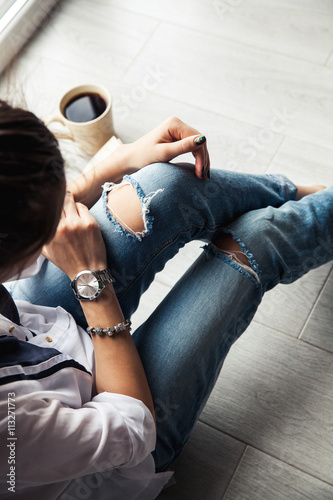 Stylish fashionable girl with a Cup of coffee and a green manicu photo