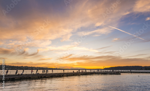 scene of walk way on the lake when sunset.