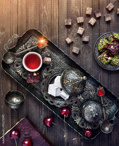 Tablou pe pânză Turkish delights and tea on the table in Istanbul