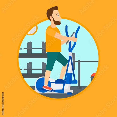 Man exercising on elliptical trainer.