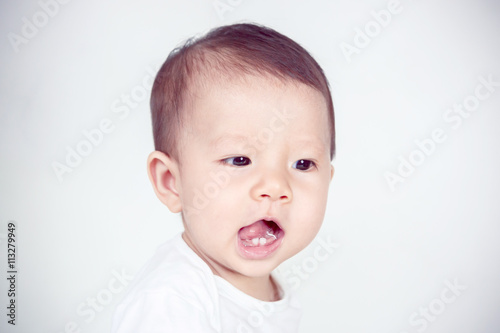 Asian baby girl smiling, studio shot (soft focus on the eyes)