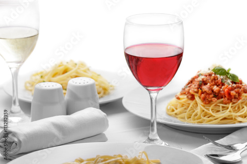 a glass of red wine served with italian pasta