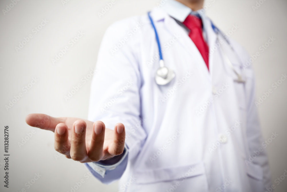 Doctor presenting blank palm of his hand in white background Doctor presenting blank palm of his hand in white background