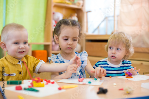 kids doing arts and crafts in day care kindergarten