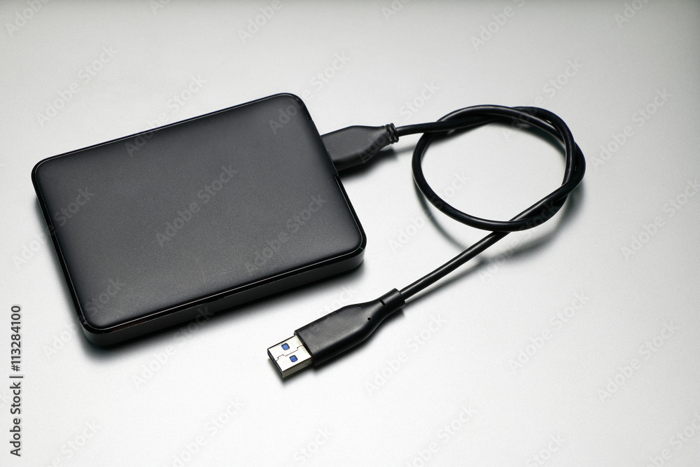 External hard drive for backup on gray background External hard drive for backup on gray background