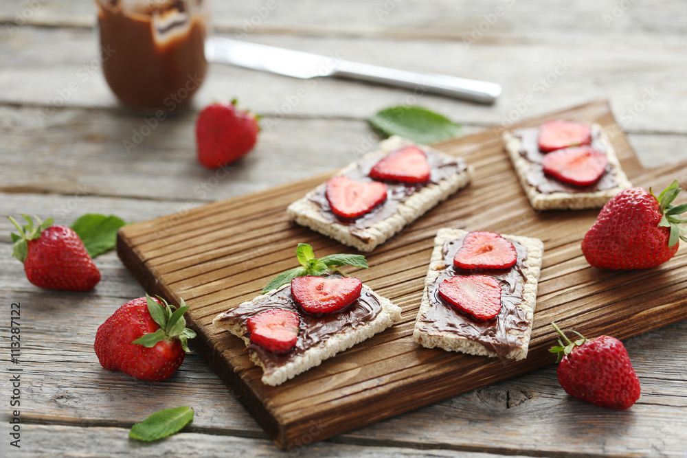 Breads with chocolate and strawberry on wooden table Breads with chocolate and strawberry on wooden table