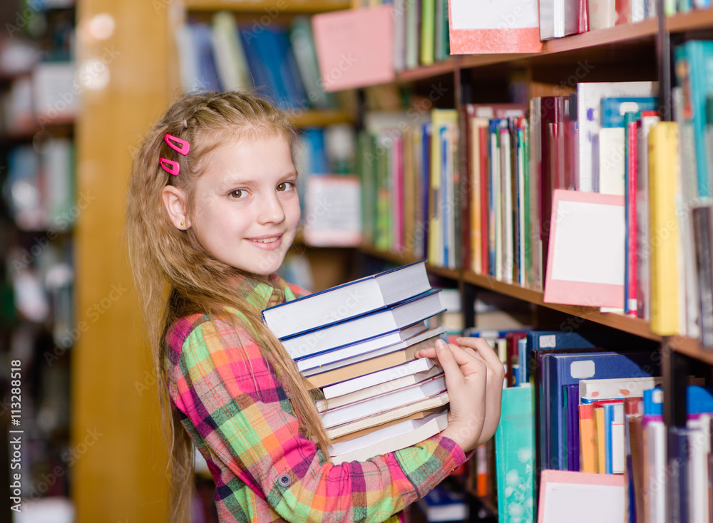teen girl with pile books in the library teen girl with pile books in the library