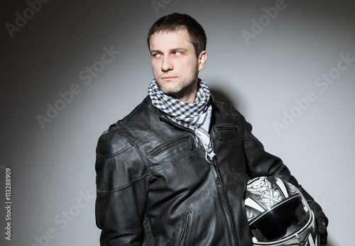 Portrait of a young man in biker's outfit