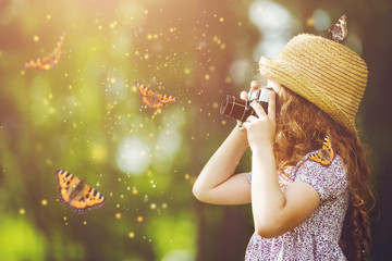 Little girl in straw hat, rustic style dress with retro photo ca