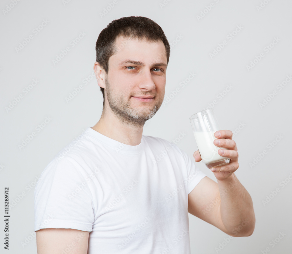 Young man holdin a glass of milk Young man holdin a glass of milk