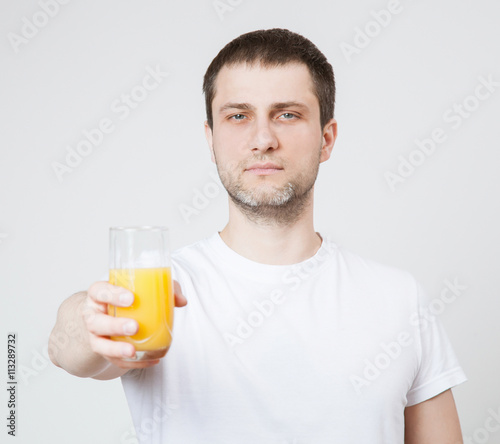 Young man holding orange juice