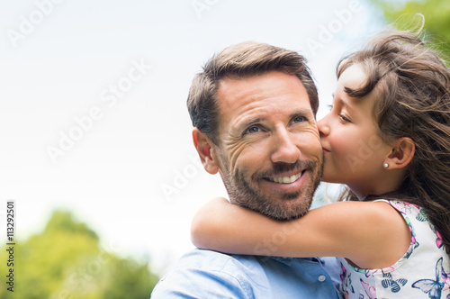 Girl kissing father