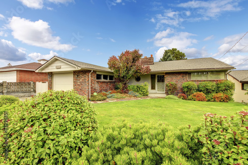 American rambler with nice front garden, well kept lawn and shru photo