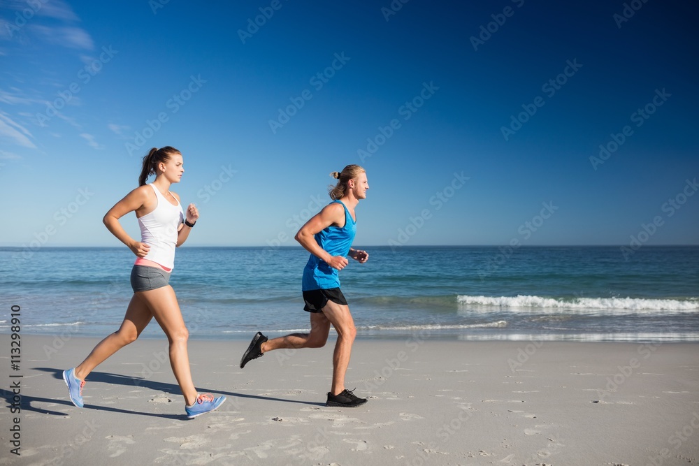 Friends jogging at the beach