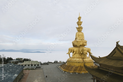 Sea of clouds surrounds the Jinding temple on the top of Golden Summit on Mount Emei Shan, Mount Emei Scenic Area, Sichuan Province, China photo