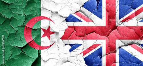 algeria flag with Great Britain flag on a grunge cracked wall