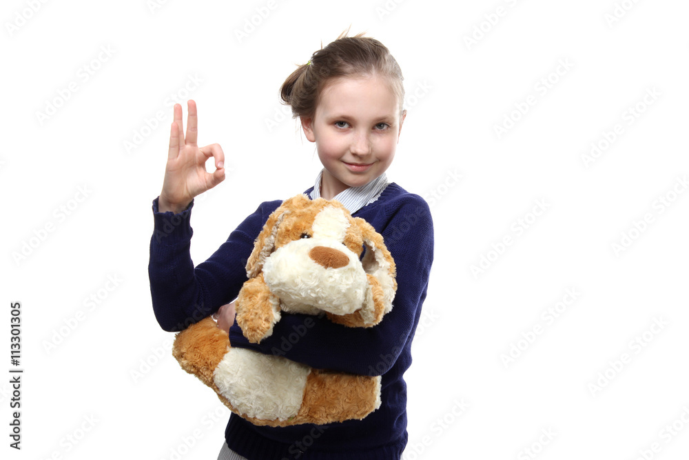 the portrait of standing young teenage beautiful girl holding a toy in her hands gesturing wearing on blue pullover and brown jeans isolated on white background the portrait of standing young teenage beautiful girl holding a toy in her hands gesturing wearing on blue pullover and brown jeans isolated on white background
