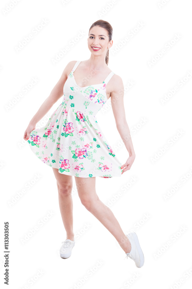 Naklejka premium Young lady showing her summer dress as studio posing