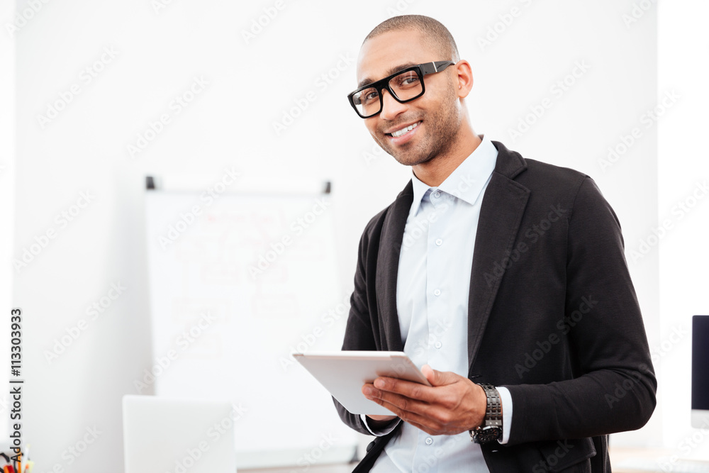 Close-up portrait of a happy businessman holding pc tablet Close-up portrait of a happy businessman holding pc tablet