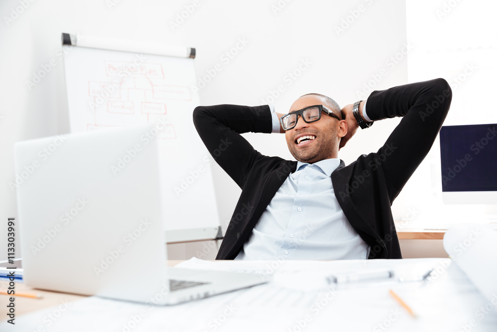 Businessman sitting back in his chair relaxing Businessman sitting back in his chair relaxing