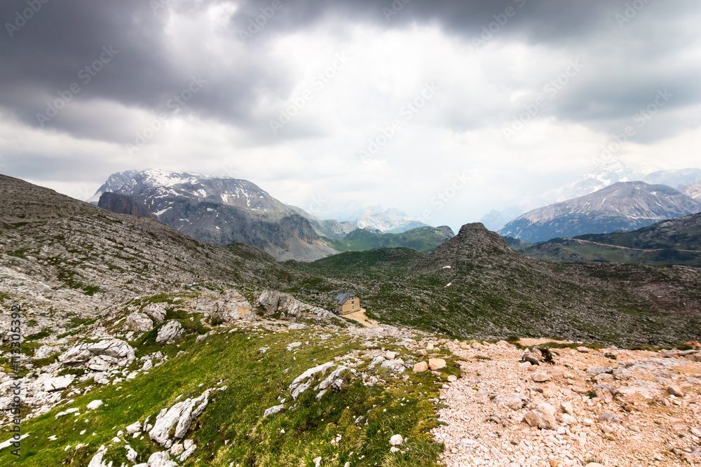 An alpine hut in the heart of the mountains before the storm, Alta Via 1 trekking route, The Dolomites, Alps, South Tyrol, Italy.