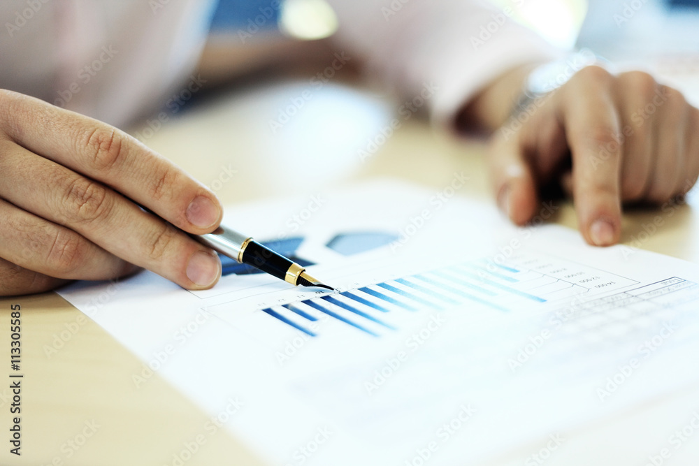 Business adviser analyzing financial figures denoting the progress in the work of company Business adviser analyzing financial figures denoting the progress in the work of company